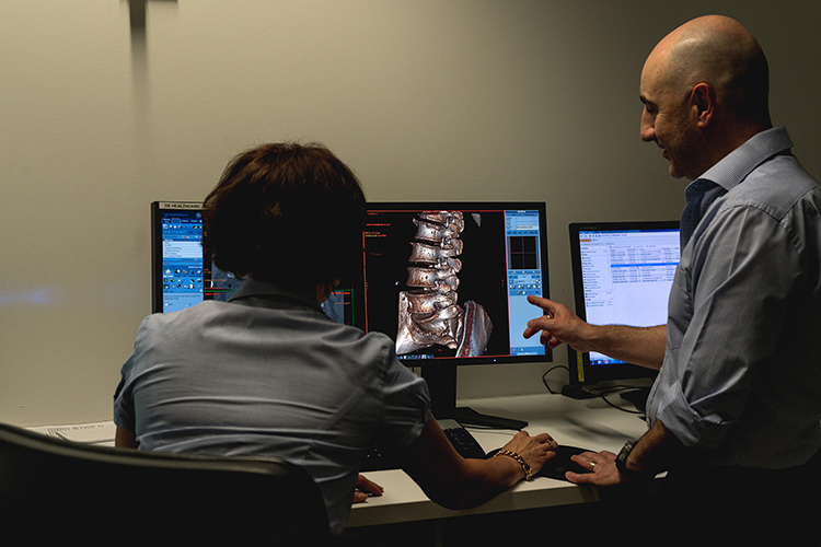 Radiologists reviewing diagnostic imaging on computer screens