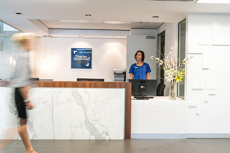 Radiology clinic reception area with staff supporting patient arrivals